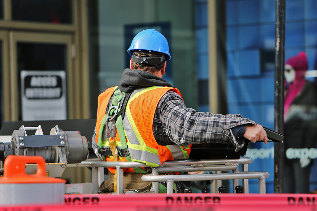 Construction worker operating a lift.